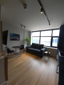 a living room with a couch and a table at Tokapa, a place between worlds in Cape Town