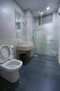 a bathroom with a toilet and a sink and a shower at Cascades Residency in Kota Damansara in Petaling Jaya