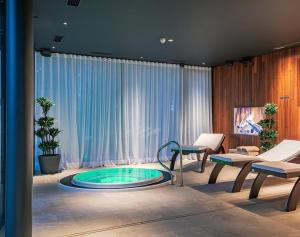 a living room with a pool in the middle of a room at Albatross Apartment Sea in Ķesterciems