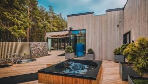 a hot tub in a courtyard in front of a building at Albatross Apartment Sea in Ķesterciems