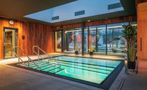 a large swimming pool in a house with at Albatross Apartment Sea in Ķesterciems