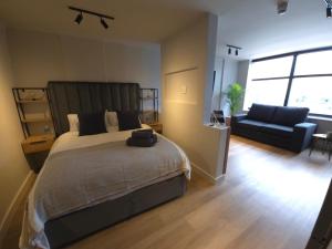 a bedroom with a large bed and a couch at Tokapa, a place between worlds in Cape Town +22 photos