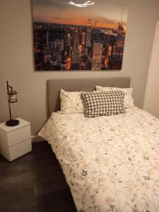 a bedroom with a bed with a painting on the wall at Lower Cheltenham Place in Bristol