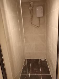 a bathroom with a shower stall with a shower at Lower Cheltenham Place in Bristol