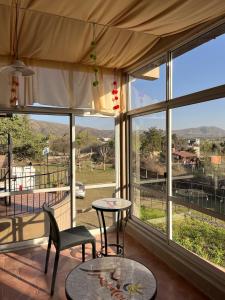 a room with a large window with a table and chairs at Montecielo in San Antonio de Arredondo