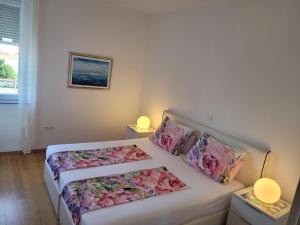 a bedroom with two beds and two lamps at Mary in Zadar
