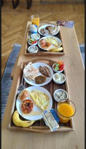 a tray with plates of breakfast food on a table at Global pyramids boutique in Cairo