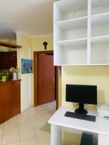 a computer sitting on a white desk in a room at Biancas House in Lezhë +12 photos