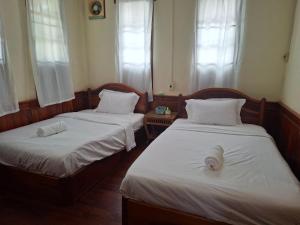 Ένα ή περισσότερα κρεβάτια σε δωμάτιο στο Vila Smile Hotel