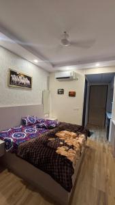 a bedroom with a large bed in a room at Sk stays in Greater Noida