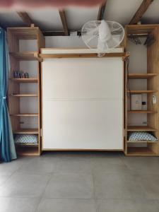 a room with a large white closet with wooden shelves at Studio Ti Bambou in La Trinité