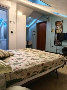 a bedroom with a bed with a floral bedspread at Greenhouse Torino in Turin