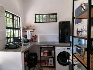 a kitchen with a sink and a washing machine at La Casita del Museo in Valladolid +21 photos