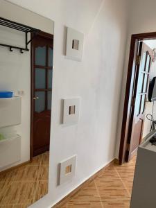 a room with a white wall with two light switches at Luxury Apartment Ritz Carlton in Sharm El Sheikh