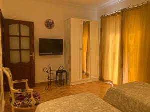 a bedroom with a bed and a tv on the wall at Luxury Apartment Ritz Carlton in Sharm El Sheikh