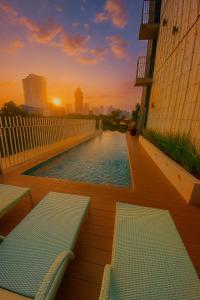 a swimming pool on the side of a building with benches at 1bedroom Lot8 condo in Cebu City
