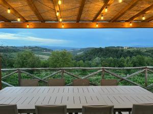 a table and chairs on a balcony with a view at Dolce Villa Toscana - private pool, air conditioning in San Gimignano