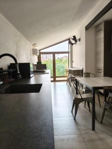 a kitchen with a table and chairs in a room at Garden House in Turin