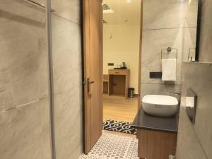 a bathroom with a sink and a toilet in it at Hotel Imperia Grand in Mohali