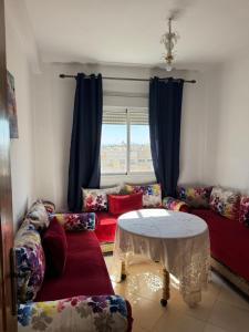 a living room with a couch and a table at Fès comfort stay in Fès +11 photos