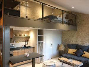 a living room with a loft bed in a room at Les Bulles De Bordeaux in Salleboeuf