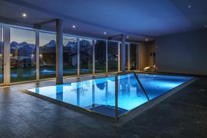 a large swimming pool in the middle of a house at Landhotel Das Stocker in Vorderstoder