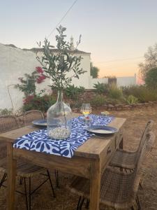 a wooden table with a vase on top of it at Monte do Luar in São Brás de Alportel