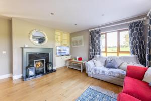 a living room with a couch and a fireplace at Thomastown property in Kilkenny