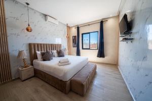 a bedroom with a bed and a television in it at Viva La Villa in Marrakech +16 photos