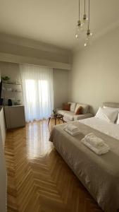 a bedroom with a large bed and a living room at Aristotelous View Suites - Smooth Living in Thessaloniki