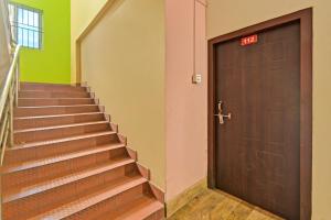an elevator with a door and stairs in a building at Hotel O Homely Residency in Guwahati