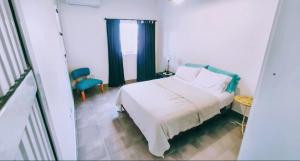 una camera da letto con un letto bianco e una finestra di A&C Temporarios III a Bañado Sur
