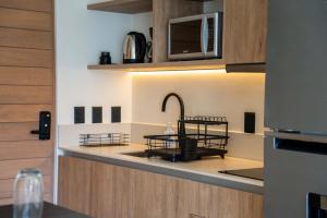 a kitchen with a counter with a table and a microwave at Versatile Studio Cowork Fast WiFi and Prime Location in Cancún