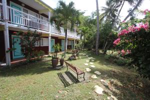 un banc dans la cour d'une maison dans l'établissement Hotel La Maison Creole, au Gosier