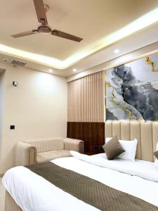 a bedroom with a bed and a painting on the wall at Celestia Omaxe in Lucknow