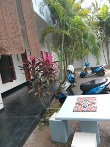 a table and scooters parked in front of a house at Villa sea 40 Ambalangoda in Wenamulla