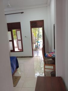 a room with a door open to a room with a table at Villa sea 40 Ambalangoda in Wenamulla