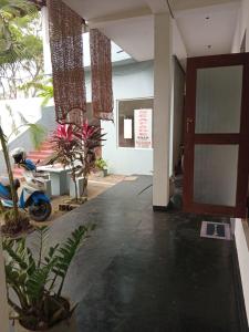 a room with a door and some plants and a motorcycle at Villa sea 40 Ambalangoda in Wenamulla