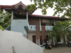 a house with a motorcycle parked in front of it at Villa sea 40 Ambalangoda in Wenamulla