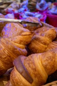 a pile of croissants sitting on a table at Hotel Ours Blanc - Victor Hugo in Toulouse