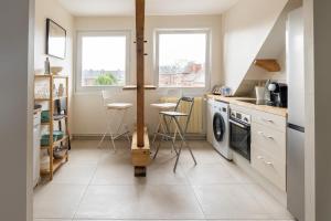 a kitchen with a stove and a dishwasher at L'Eclat des Halles - Hypercentre in Amiens +18 photos