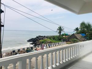 a balcony with a view of the ocean at Virtus home stay in Pondicherry