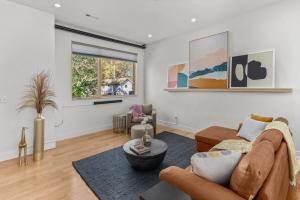 a living room with a couch and a table at Luxury Downtown Townhome - 120 Theater & Patio in Bentonville