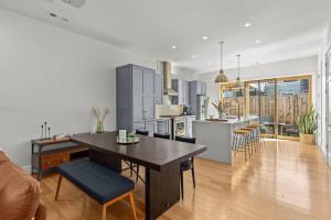 a kitchen and living room with a table and a dining room at Luxury Downtown Townhome - 120 Theater & Patio in Bentonville