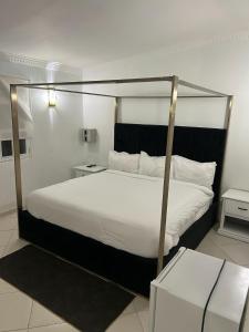 a bedroom with a large bed with a canopy at Hannabi Hotel in Boca Chica