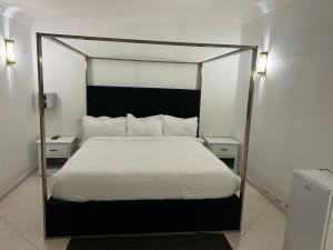 a bedroom with a large bed with a black frame at Hannabi Hotel in Boca Chica