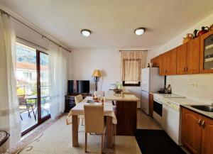 a kitchen with a table and a dining room at Apartments Andrija in Kotor