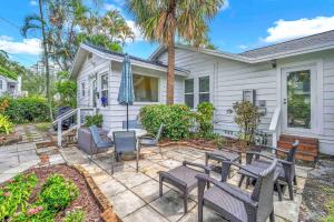 a home with a patio with tables and chairs at Bromeliad Bungalow - Downtown Cottage in Fort Lauderdale