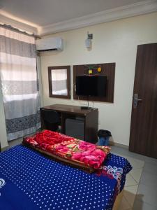 a room with a bed with roses on it at Tranquils Homestay in Abuja