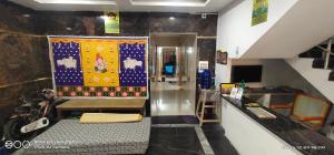 a room with a table with a tapestry on the wall at Shree chendur Residency in Tiruvannāmalai